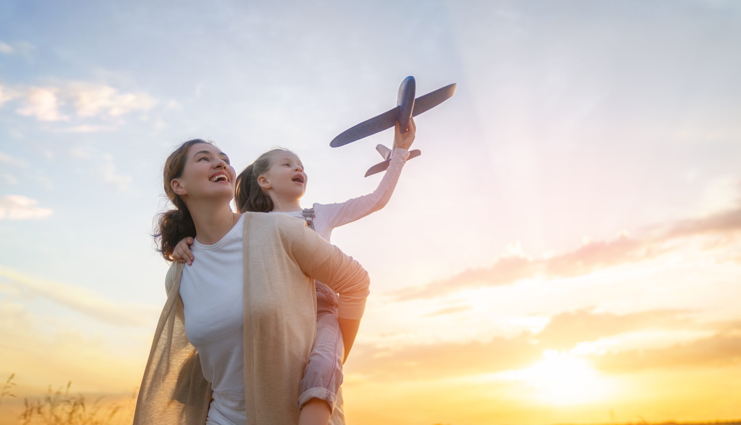 Happy,Family,,Mother,And,Kid,With,Toy,Plane,Are,Running